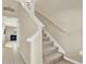 Interior staircase with carpeted steps and white railing leading to the second floor at 5067 Sable Chime Dr, Wimauma, FL 33598