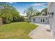 A beautifully landscaped backyard with a storage shed, green lawn, and stone walkway at 526 62Nd Ne Ave, St Petersburg, FL 33702