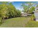 Backyard featuring lush landscaping, green lawn, and a storage shed at 526 62Nd Ne Ave, St Petersburg, FL 33702