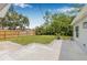A spacious backyard featuring green lawn, stone accents, and a wooden fence at 526 62Nd Ne Ave, St Petersburg, FL 33702