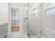 Bathroom features glass enclosed shower, modern fixtures, and tile flooring with view to the walk-in closet at 526 62Nd Ne Ave, St Petersburg, FL 33702