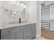 Bathroom features double vanity with quartz countertop, two oval mirrors, and a walk-in closet view at 526 62Nd Ne Ave, St Petersburg, FL 33702