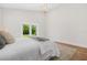 A bright bedroom featuring stylish chandelier, white walls, and sliding glass doors that offers outdoor views at 526 62Nd Ne Ave, St Petersburg, FL 33702