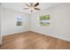 Bright bedroom with hardwood flooring, large windows with blinds, and a ceiling fan for a cozy feel at 526 62Nd Ne Ave, St Petersburg, FL 33702