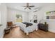 Comfortable bedroom features new floors, a ceiling fan, and bright natural light at 526 62Nd Ne Ave, St Petersburg, FL 33702