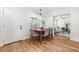 Cozy dining area with wood floors, a modern light fixture, and seating for six at 526 62Nd Ne Ave, St Petersburg, FL 33702