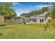 A well-manicured lawn and backyard featuring a covered patio and additional storage at 526 62Nd Ne Ave, St Petersburg, FL 33702