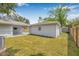 A well-maintained home exterior with a lawn, connected to a covered patio with backyard access at 526 62Nd Ne Ave, St Petersburg, FL 33702