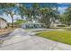A beautifully landscaped single-story home with a long driveway and mature trees at 526 62Nd Ne Ave, St Petersburg, FL 33702
