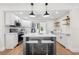 Updated kitchen featuring stainless steel appliances, a central island, and bright white cabinetry at 526 62Nd Ne Ave, St Petersburg, FL 33702