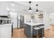 Bright kitchen features a gray island with seating, stainless steel appliances, and white cabinets at 526 62Nd Ne Ave, St Petersburg, FL 33702
