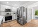 Updated kitchen boasting stainless steel appliances and white cabinets at 526 62Nd Ne Ave, St Petersburg, FL 33702