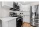 Bright kitchen features stainless steel appliances, sleek countertops, and white cabinetry at 526 62Nd Ne Ave, St Petersburg, FL 33702