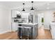 Bright, updated kitchen featuring white cabinets, stainless steel appliances, and a central island at 526 62Nd Ne Ave, St Petersburg, FL 33702