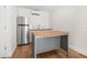 A modern kitchen with stainless steel appliances, sleek cabinets, and a wood-topped island at 526 62Nd Ne Ave, St Petersburg, FL 33702