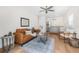 A cozy living room with modern decor, a ceiling fan, and an adjacent kitchen at 526 62Nd Ne Ave, St Petersburg, FL 33702