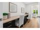 Bright, modern office space with built-in desk, drawers, decor and view of the bedroom through an open door at 526 62Nd Ne Ave, St Petersburg, FL 33702