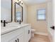 Updated bathroom with double vanity, modern fixtures, and subway tile at 5470 Bayshore Dr, Seminole, FL 33772
