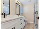 Modern bathroom with dual sinks, white cabinets, and a glass shower at 5470 Bayshore Dr, Seminole, FL 33772