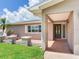 Covered front porch with brick accents, offering a welcoming entrance to this lovely home at 5470 Bayshore Dr, Seminole, FL 33772