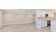 Open floor plan featuring a bright kitchen with white cabinets and an expansive, open living area at 5470 Bayshore Dr, Seminole, FL 33772