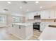 Spacious kitchen with white cabinets, stainless steel appliances, and a large center island at 5470 Bayshore Dr, Seminole, FL 33772