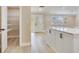Bright kitchen with a pantry, island with white cabinets, and natural light from the windows at 5470 Bayshore Dr, Seminole, FL 33772