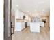 Bright, open-concept kitchen with white cabinets, an island, and modern appliances, blending seamlessly into the living space at 5470 Bayshore Dr, Seminole, FL 33772