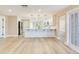Open kitchen with a large island, stainless steel appliances, and white cabinets and natural light at 5470 Bayshore Dr, Seminole, FL 33772