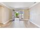 Bright living room featuring French doors to outdoor patio and light wood flooring at 5470 Bayshore Dr, Seminole, FL 33772
