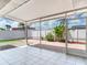 Covered patio with white tile flooring and serene outdoor view at 5470 Bayshore Dr, Seminole, FL 33772