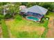 An aerial view showcasing a screened pool, well-maintained lawn, and the property's landscaped surroundings at 5825 Terncrest Dr, Lithia, FL 33547
