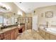 The primary bath showcases a granite vanity, soaking tub, and glass shower, combining luxury and functionality at 5825 Terncrest Dr, Lithia, FL 33547