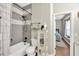 Well-lit bathroom features a shower-tub combo with stylish gray tile and wood-look floors at 5825 Terncrest Dr, Lithia, FL 33547