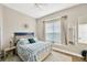 Cozy bedroom with blue accents, window seat, and neutral decor, offering a peaceful retreat at 5825 Terncrest Dr, Lithia, FL 33547