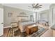 The neutral bedroom is a serene space, complete with wood floors, ceiling fan, and decorative accents at 5825 Terncrest Dr, Lithia, FL 33547