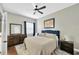 Bedroom featuring a large bed, dresser, modern finishes, and neutral paint at 5825 Terncrest Dr, Lithia, FL 33547
