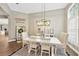 Inviting dining room featuring hardwood floors, neutral decor, and an elegant light fixture at 5825 Terncrest Dr, Lithia, FL 33547