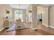 Elegant dining room with hardwood floors, decorative columns, and a view of the foyer and entryway at 5825 Terncrest Dr, Lithia, FL 33547