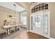 Bright foyer with decorative front door, wood floors, and dining area with stylish light fixture and window shutters at 5825 Terncrest Dr, Lithia, FL 33547