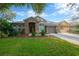 Charming home with stone accents, well-manicured lawn, mature trees, and inviting curb appeal at 5825 Terncrest Dr, Lithia, FL 33547