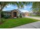 Charming home with stone accents, well-manicured lawn, mature trees, and inviting curb appeal at 5825 Terncrest Dr, Lithia, FL 33547