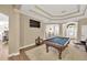 Open game room with pool table, media setup, and seamless flow to the dining and kitchen areas at 5825 Terncrest Dr, Lithia, FL 33547
