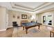 Spacious game room featuring a pool table, coffered ceiling, and access to outdoor area at 5825 Terncrest Dr, Lithia, FL 33547