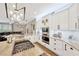 Well-appointed kitchen features white cabinetry, granite countertops, stainless appliances, and a gas cooktop island at 5825 Terncrest Dr, Lithia, FL 33547