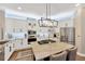 Modern kitchen boasts white cabinets, stainless steel appliances, a large island, and stylish pendant lighting at 5825 Terncrest Dr, Lithia, FL 33547