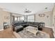 Inviting living room with a large sectional sofa and views of the screened porch and backyard at 5825 Terncrest Dr, Lithia, FL 33547