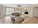 Cozy living room featuring a comfortable leather sofa, lots of natural light, and neutral decor at 5825 Terncrest Dr, Lithia, FL 33547