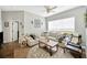 Living room with hardwood floors, area rug, comfortable sofa, and natural lighting at 5825 Terncrest Dr, Lithia, FL 33547
