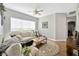 Living room showcasing modern furniture, decor, ceiling fan, and hardwood flooring at 5825 Terncrest Dr, Lithia, FL 33547